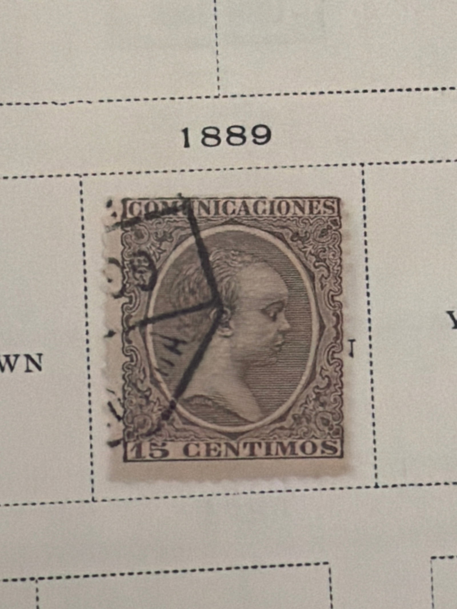 1889 Spain Queen Regent Mar?a Cristina 15-Centimos Used Stamp: Single 1889 Spanish 15-centimos portrait stamp featuring Queen Regent Mar?a Cristina. The stamp has a prominent postal cancellation and visible age-related condition consistent with the photograph. Th