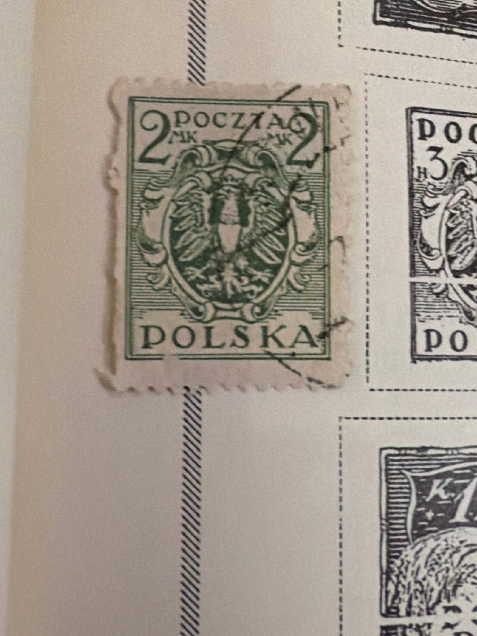 1918-1920 Poland Eagle and Allegorical Stamp Pair: Pair of early Polish stamps from approximately 1918-1920, including green and brown-red examples with national and allegorical imagery. No clear postal cancellations are visible in the photograph. Bla