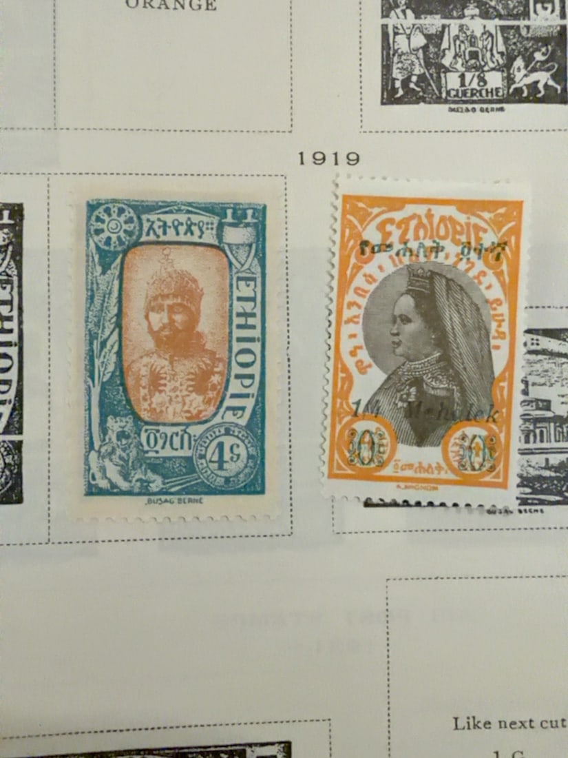 1919 Ethiopia Portrait Postage Stamps Pair: Pair of early Ethiopian postage stamps dated to the 1919 section of the album. Includes two colorful portrait designs with Ethiopian script and visible postal or surcharge markings. Please review the 