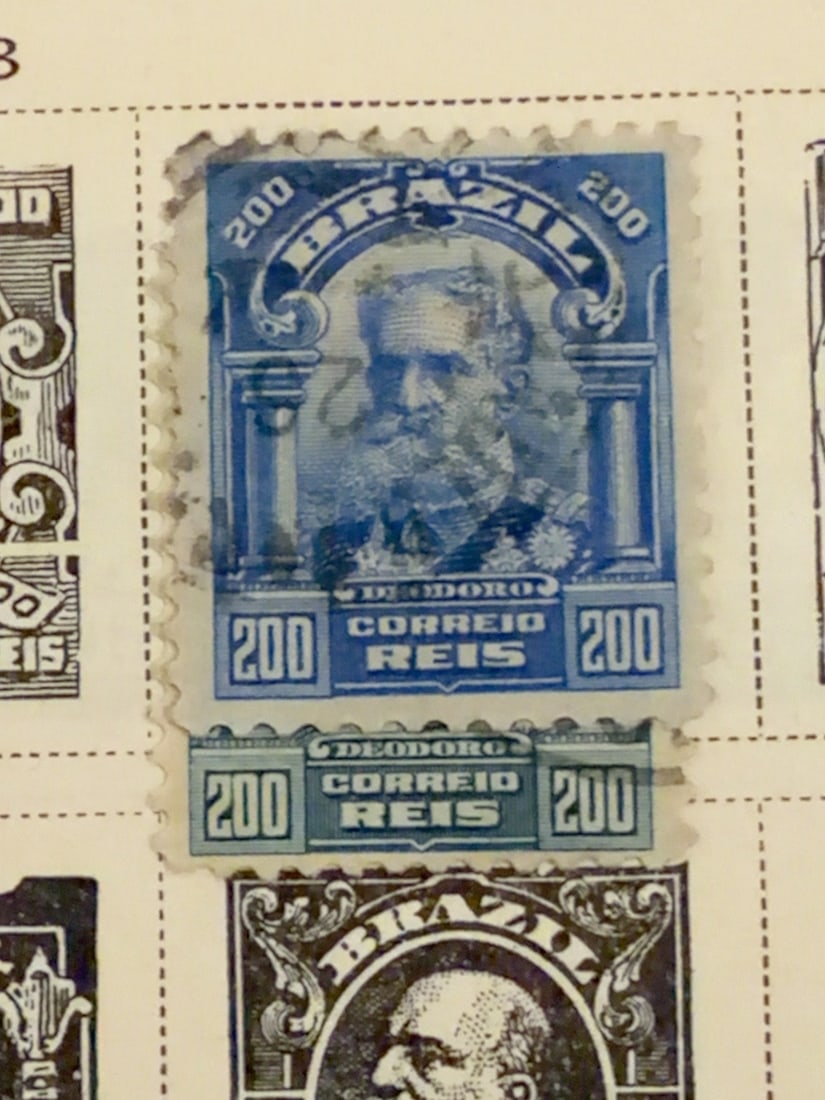 Vintage Brazil Dom Pedro II 200 Reis Postage Stamp: Vintage Brazilian 200-reis postage stamp featuring Emperor Dom Pedro II in an ornate blue portrait design. This example retains an attached lower inscription or label section and shows visible postal 