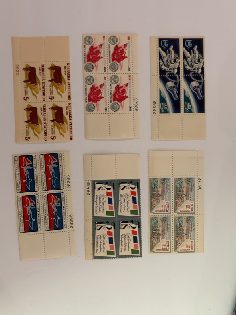 U.S. 1960s Nebraska Nevada Space & Historic Plate Blocks: Group of six vintage U.S. four-stamp plate blocks commemorating Nebraska Statehood, Nevada, the Battle of New Orleans, space exploration, international cooperation and Finnish independence. Blocks ret