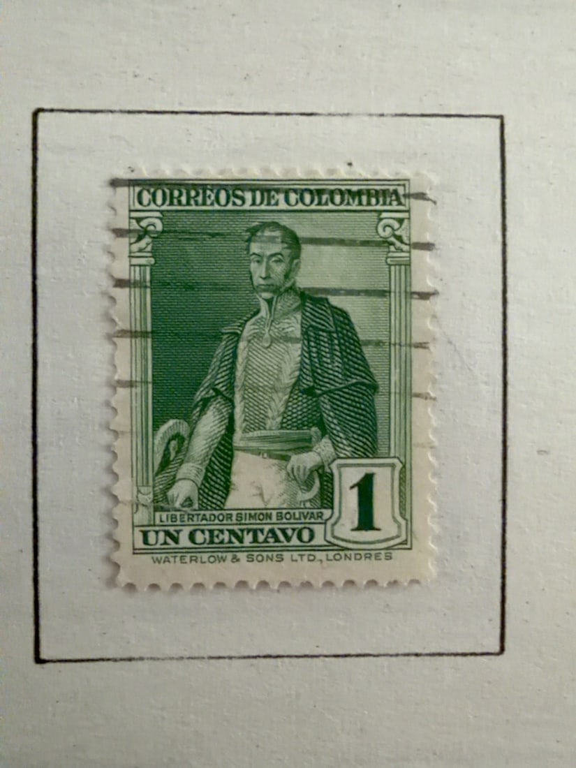 Colombia 1-Centavo Sim?n Bol?var Green Stamp: Vintage Colombia 1-centavo green postage stamp portraying Libertador Sim?n Bol?var. Used example with horizontal cancellation and visible age wear. Mounted on an album page and offered as