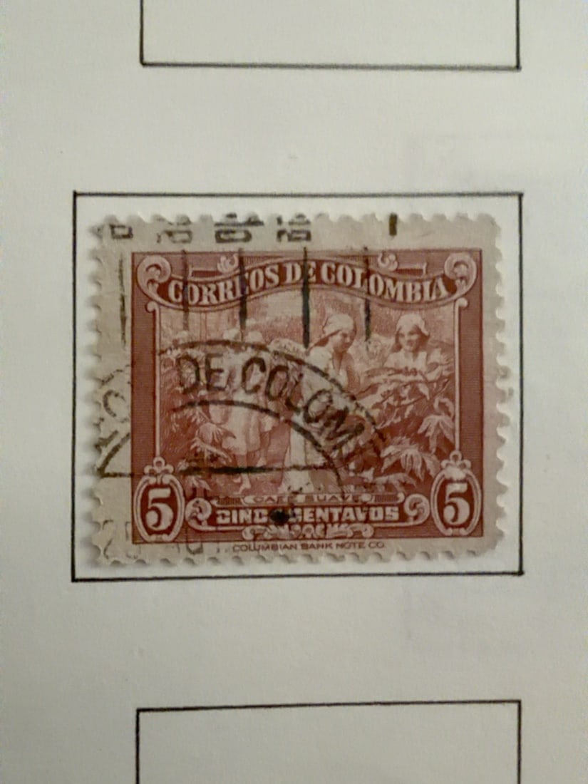 Colombia 5-Centavos Coffee Industry Stamp: Early Colombian 5-centavos brown postage stamp featuring a detailed coffee-production scene. Used example with a prominent cancellation across the design. Visible age and edge wear; condition as photo