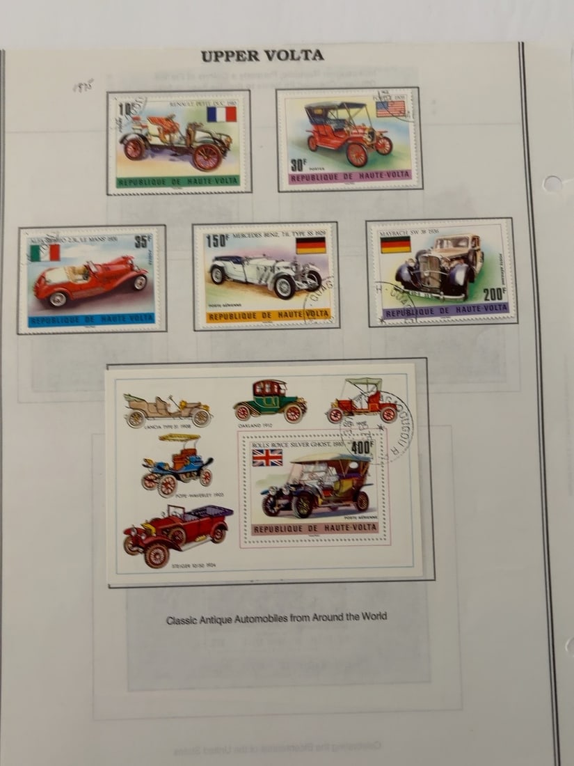 Upper Volta Classic Automobile Stamp Collection: Group of five Upper Volta stamps and one souvenir sheet depicting classic automobiles from France, the United States, Italy, Germany and Great Britain. Cancellation markings visible; mounted on a
