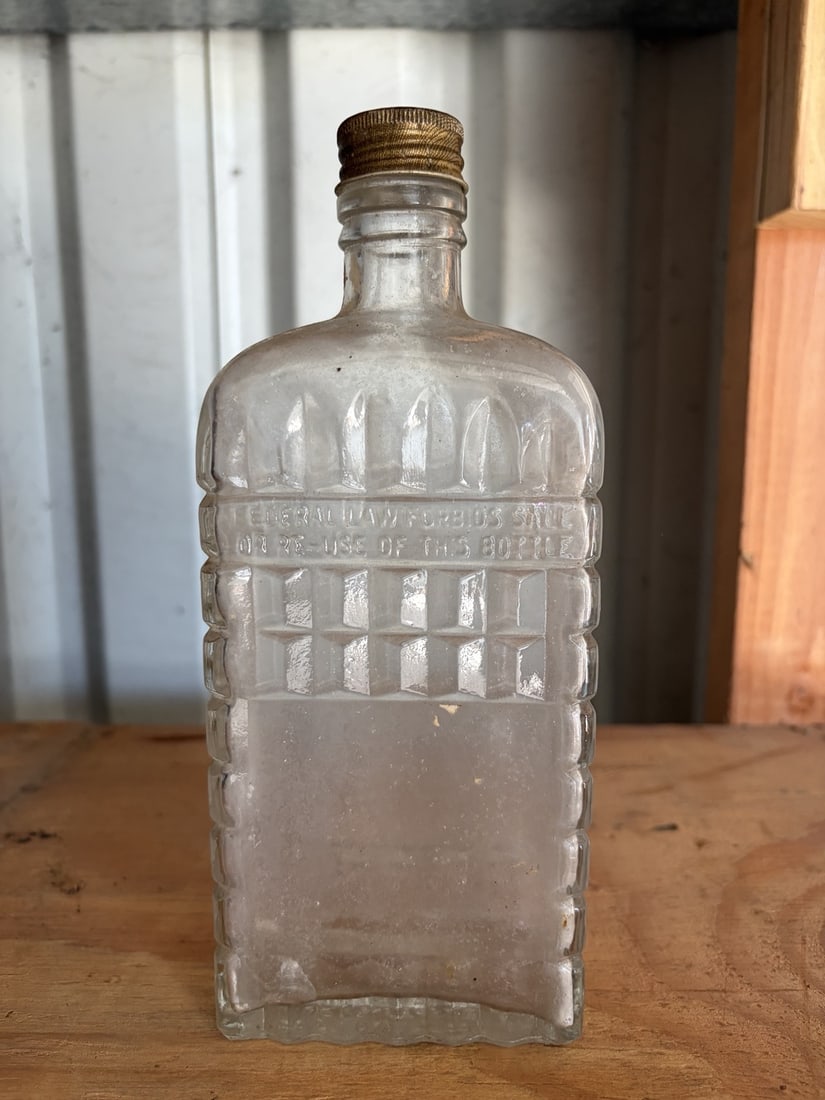 Antique e Liquor Bottle: sold as shown.