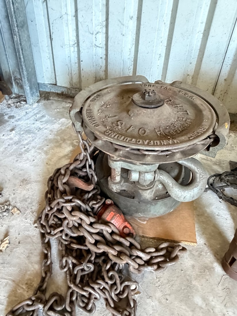 Antique Yale & Towne Chain Hoist: Antique heavy-duty Yale & Towne chain hoist with cast metal housing, hook and substantial length of chain. Industrial barn, shop or railroad-era equipment with aged surface wear, oxidation and old