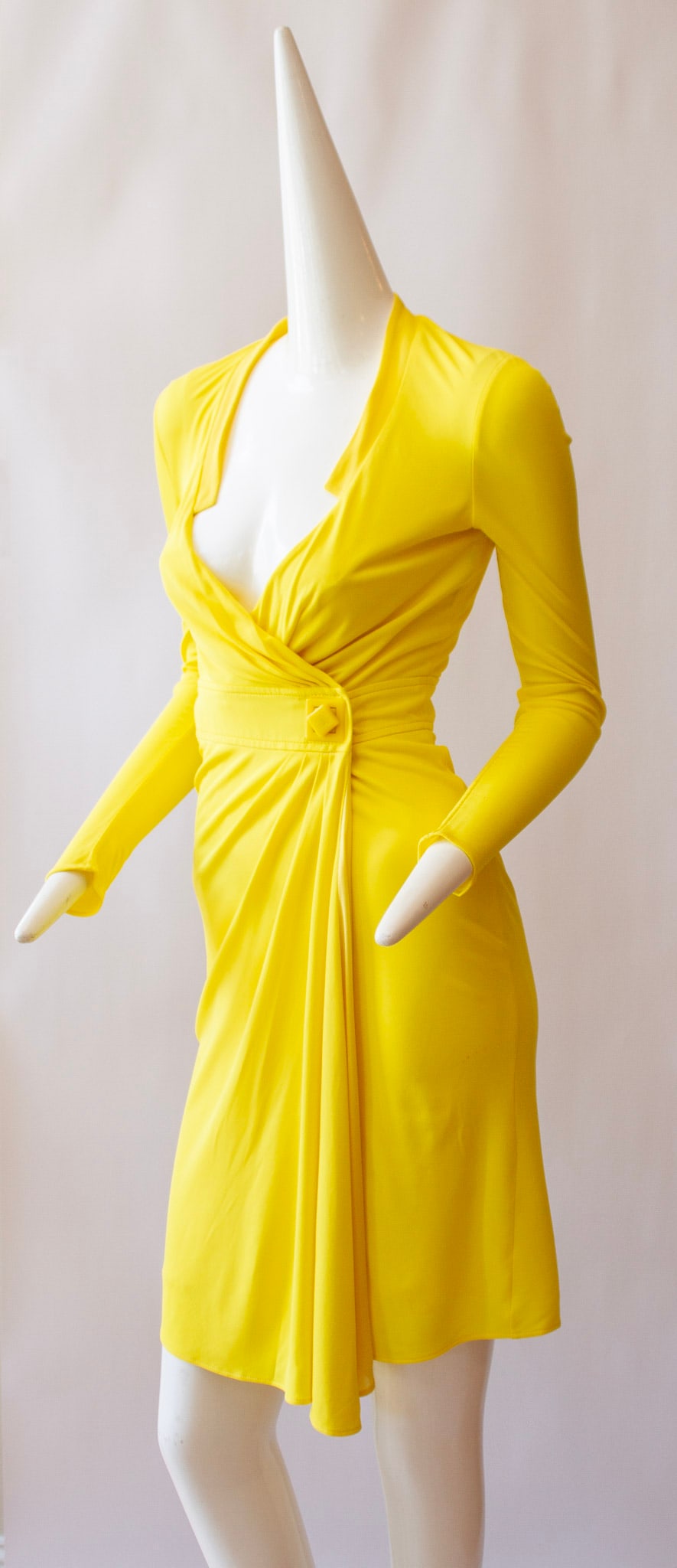 GIANNI VERSACE, Canary Yellow Mid-Length Wrap Dress with Rotating Square Medusa Fastener: GIANNI VERSACE, Canary Yellow Mid-Length Wrap Dress with Rotating Square Medusa Fastener. Long Sleeves and Plunging NecklineGIANNI VERSACE, Canary Yellow Mid-Length Wrap Dress with Rotating Square Med