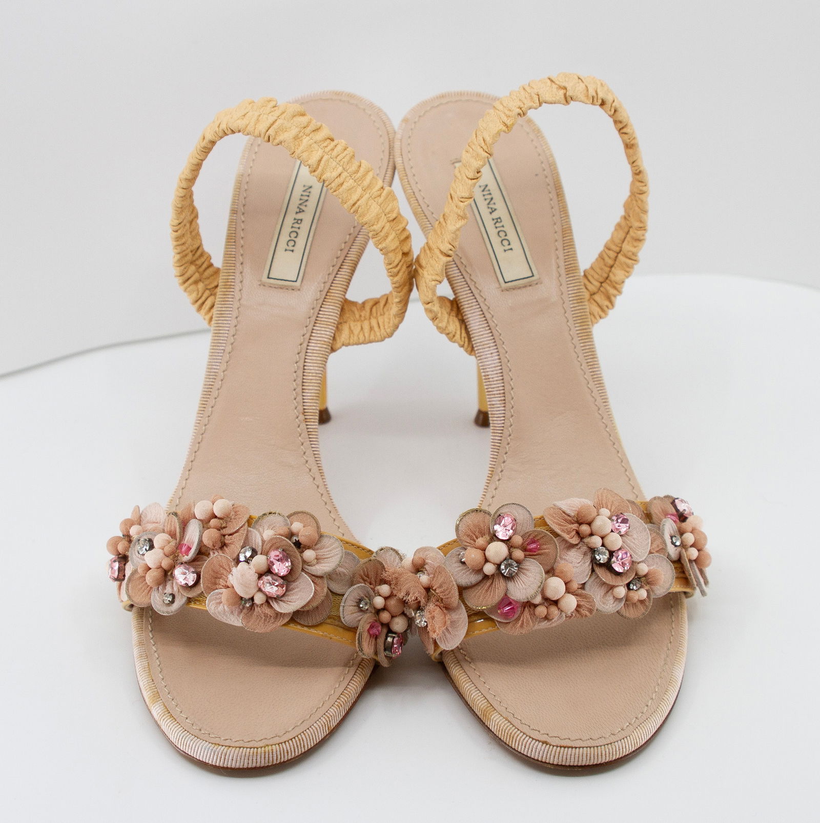 NINA RICCI Slingback Sandals: NINA RICCI Slingback Sandals with Jeweled Flowers in BlushNina Ricci Slingback sandals, decorated with jeweled flowers, in blush patent leather.Nina Ricci : Size 40, Heel 2.5" NO RESERVE