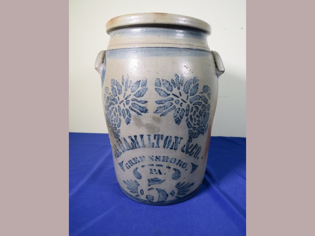 5 gal. James Hamilton & Co. w/ Elaborate Stenciled: Greensboro, PA. Nice cobalt at the handles. 4" crack on bottom right, spider cracking, small chip on inner rim.