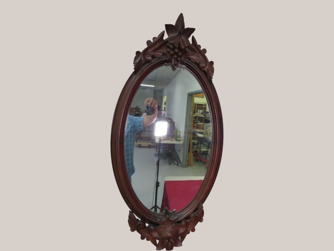 French Black Forest Walnut Carved Oval Mirror: 2 inch Crack towards top 42 x 22 x 3