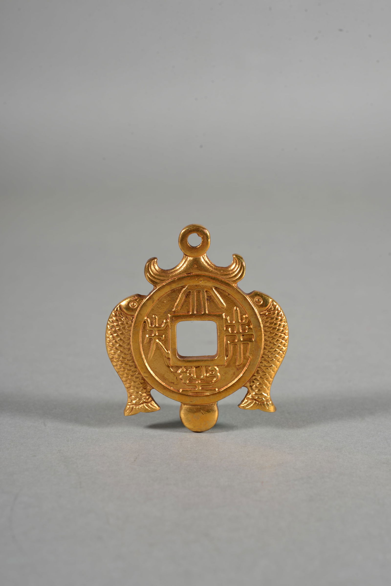 A GILT-BRONZE COIN (1 of 3)