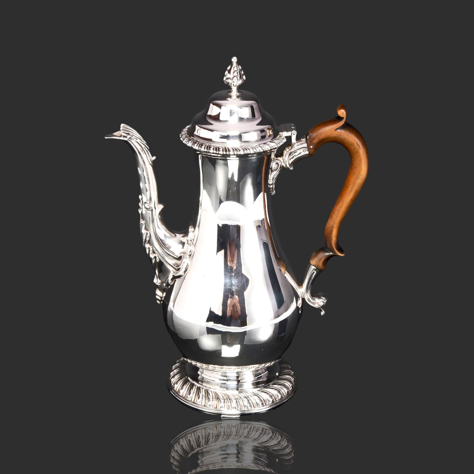 GEORGE III STYLE STERLING SILVER COFFEE POT, LONDON, 1910, CHARLES STUART HARRIS: Edwardian silver coffee pot recreated from a design made popular in 1760 during the reign of King George III of England. This silver coffee pot is fitted with an elegant fruitwood handle. H 270mm W 19