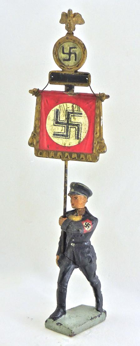 Rare Lineol SS Man March with Standard: Figure with thin neck crack and some light wear with original paint and armband. Standard original with some scratches to white circle on front. Swastika remains complete and legible. Man plus standar
