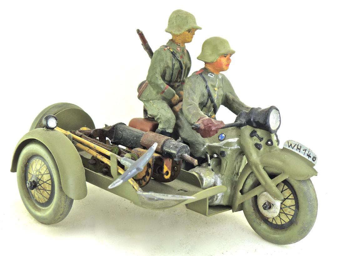 Hausser Motorcycle with Gun on Sidecar Rider: Cap firing gun with light wear. It cocks and fires. Rider ok with rifle tip missing. 2 Tools on side. Some touch-up to driver and parts of cycle. Wheels and sidecar all original. Motorcycle Rider 2 To
