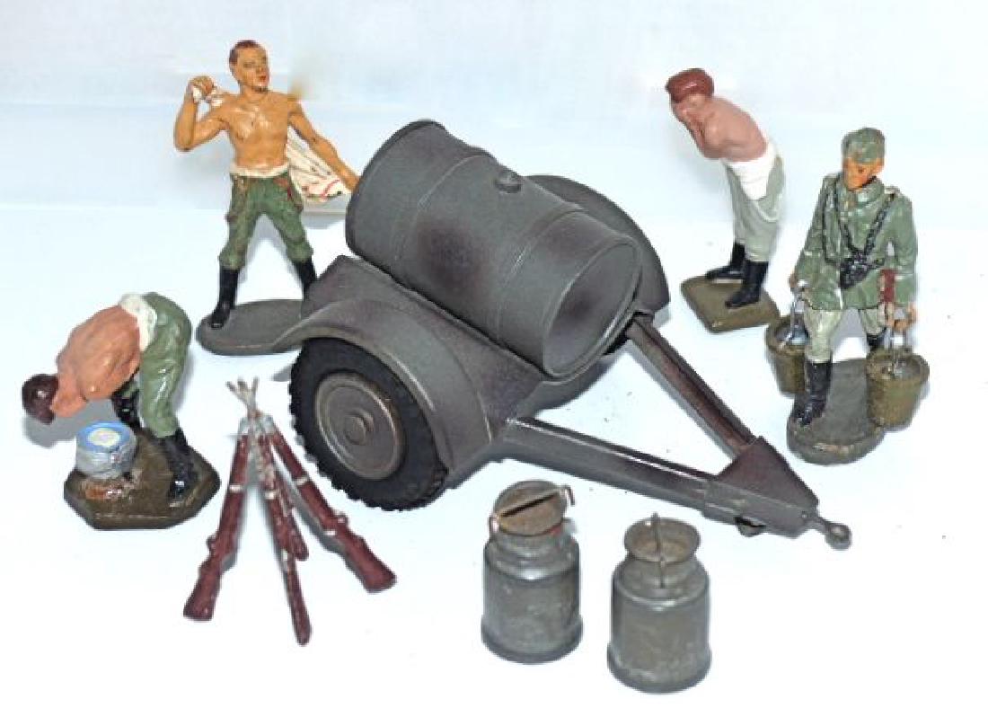 Duscha Lineol Elastolin Camp Figures: Potable water trailer by Duscha. Rubber tires with Lineol logo. Rifle stack by Lineol with light wear. Krock figure washing like new. 2 Elastolin both very good. 2 milk cans very good. 8 Pieces. 7.5 c
