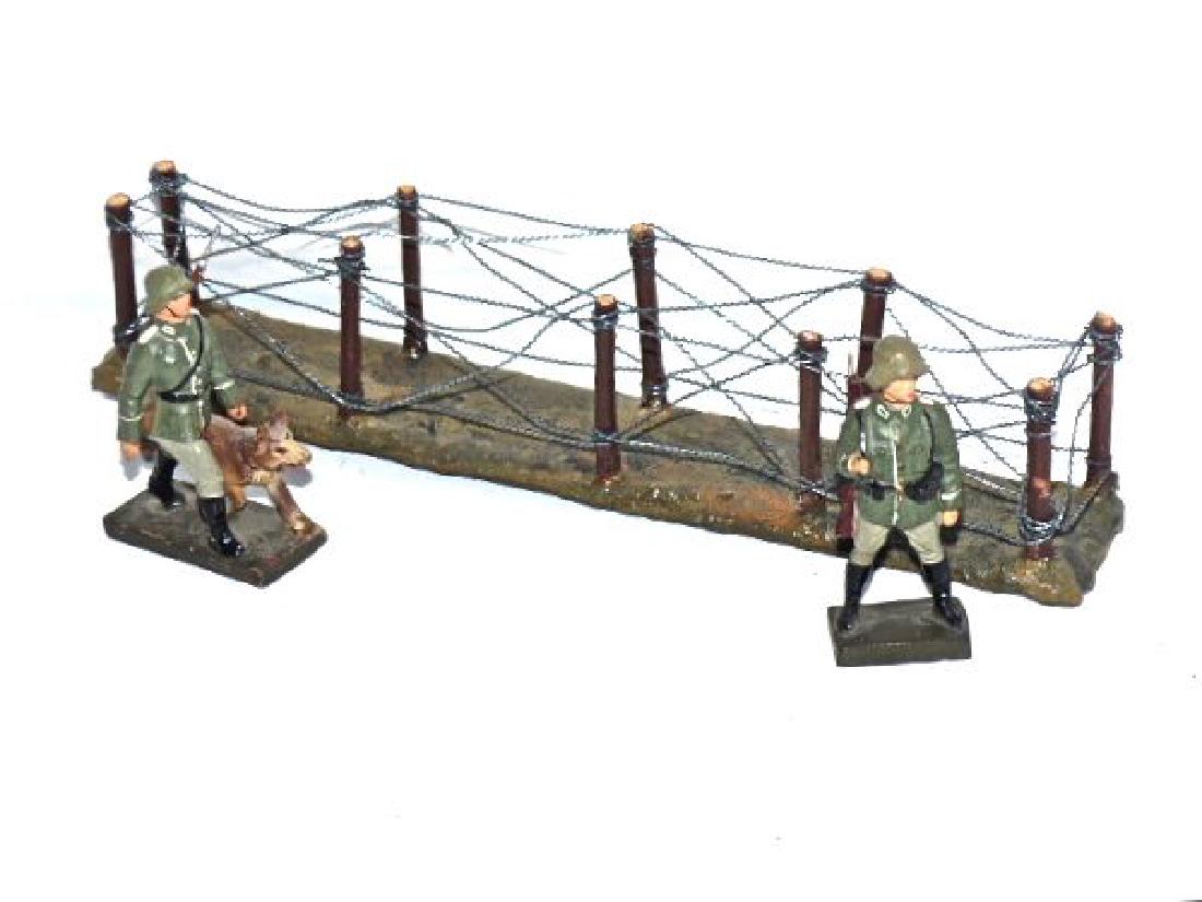 Lineol 2 Guards 1 with Dog Barbed Wire Span: Barbed wire span is by Reiner Krock. Neat detail and like new. About 20 years old. Guard with dog has no cracks with some light wear to include few chips to pants. Guard with slung rifle has thin neck