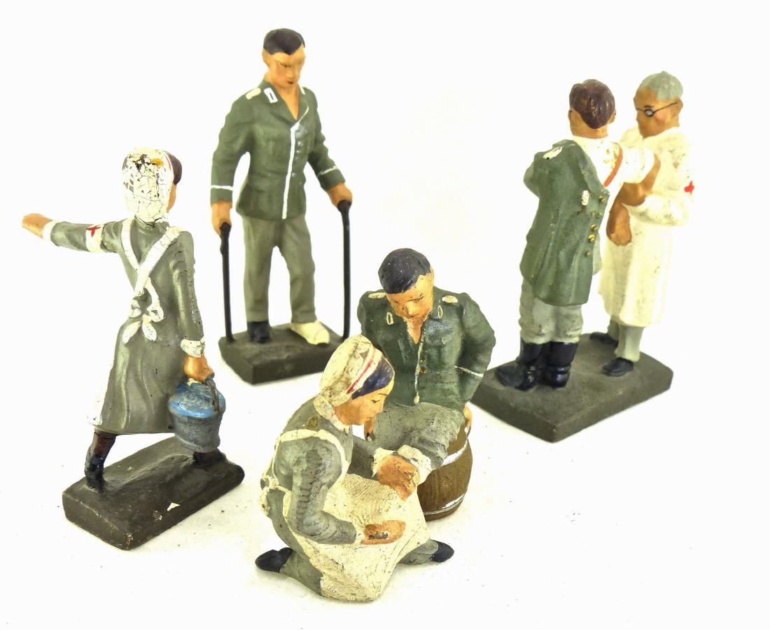 Lineol 4 Medical on Canes Nurse 2 Dual Figures: Wounded on canes has no cracks or apparent wear! The other 3 figures are 6.5 cm. The were made 1928-39 and sold with the newer 7.5 cm figures. They have no cracks with face of wounded on keg touched u