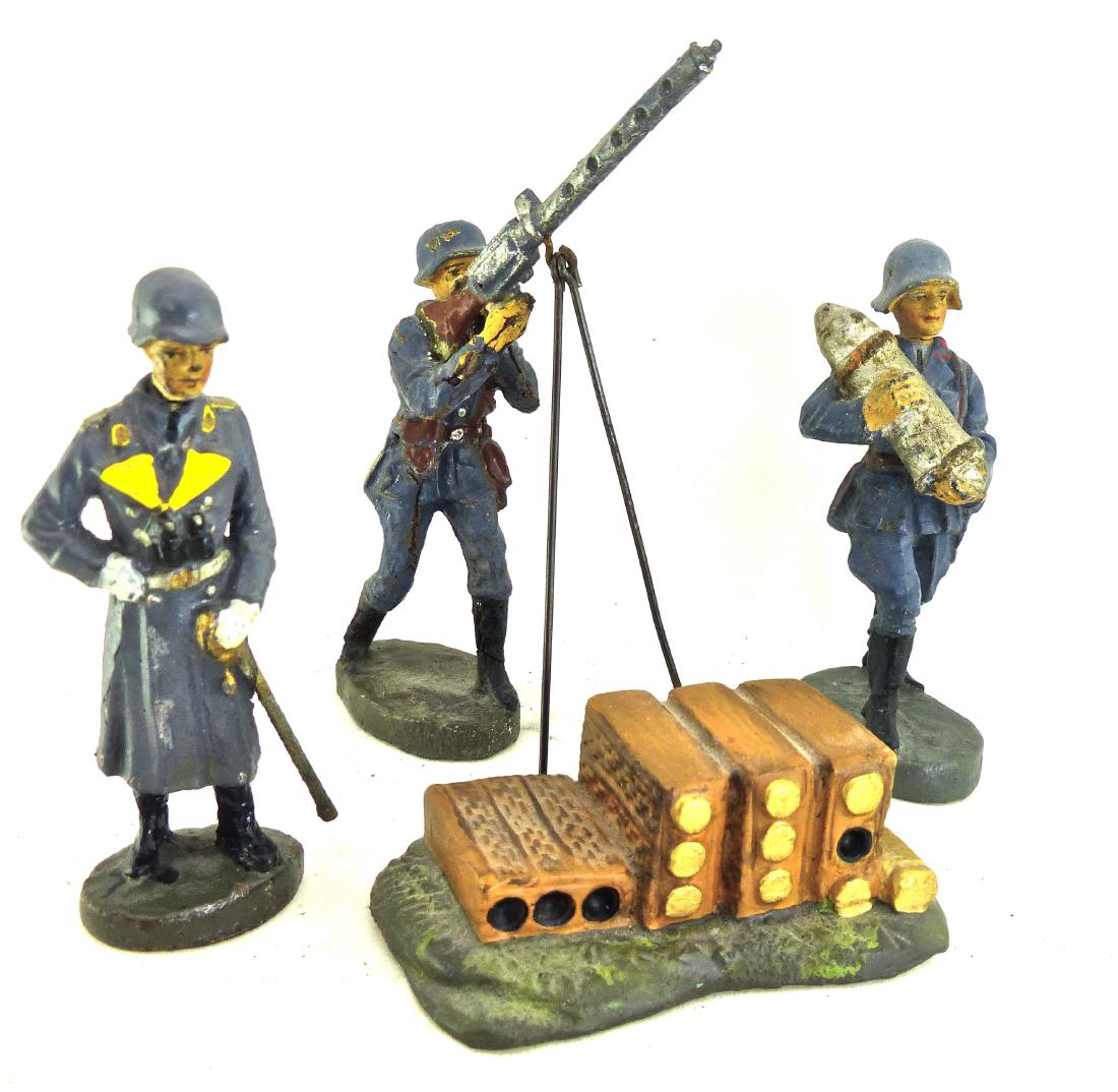 Elastolin 3 Luftwaffe Gen with AA Gun with Shell: Shell stack group is a Krock piece. Post War with no wear. General with coat lapels touched up. Figures have few minor cracks and some light wear. 4 Pieces. 7 cm. Figures made about 1936-40. Very Good