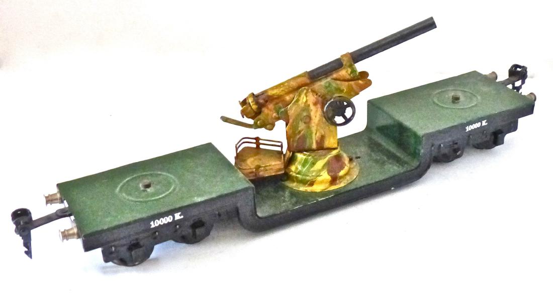 Marklin SPUR O Flat Car with AA Gun: Car length is 31 cm. about 12 inches. Excellent paint with no scratches. Original Marklin camouflage on AA gun. It cocks and fires normally. All fittings/ wheels intact. 1 piece. O Gauge. Made about 1