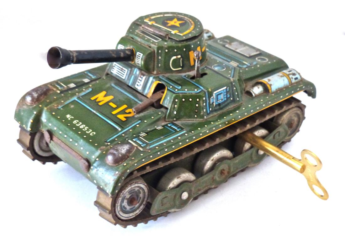Postwar Gama Tank Rubber Treads with Key: Gama M-12 Post War tank with motor. Tank runs well and it comes with a key. Tin lithographed body is intact with some light wear. Little machine gun missing the flint. Rubber treads both in good condi