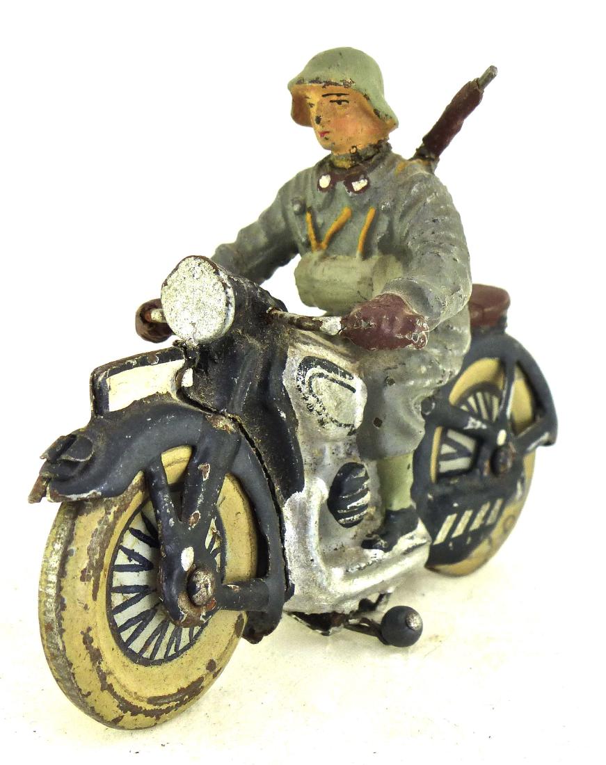 Lineol Swiss Weather Coat on Motorcycle: Cracks to neck, rifle and waist. Driver is a 2 piece mold joined at the waist. Some wear to cycle and wheels which move freely. Driver wears a Swiss style helmet. 1 Piece. 7.5 cm. Made ONLY 1938-39. V
