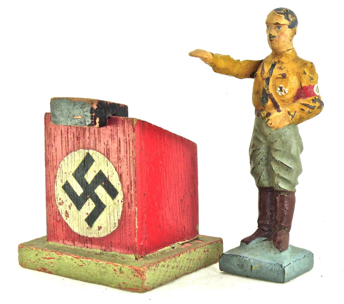 Lineol SA Hitler Army Pants at Elastolin Podium: Very Scarce. Rare to see this Hitler figure in German army green pants and not the usual SA brown. Thin partial neck and leg cracks with some touch-up to top of right arm. Very good face, paint and an