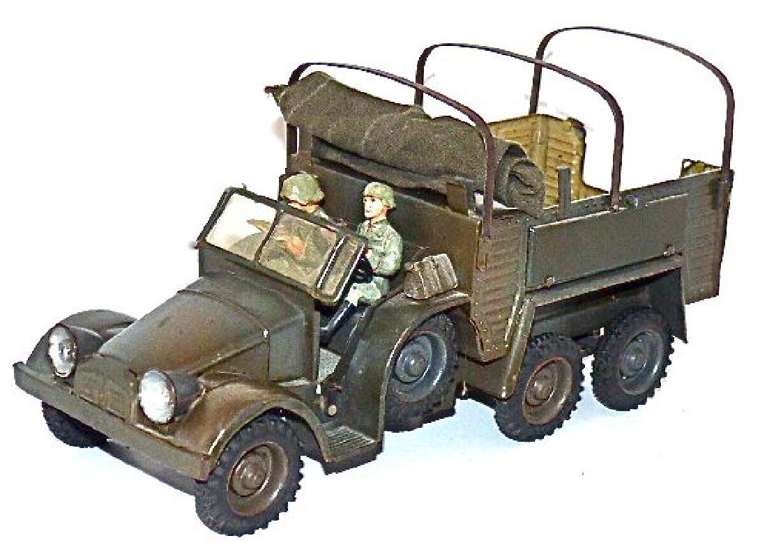 Lineol Krupp truck 3 Axles Gray Version: Almost 10 inches long.8 Rubber tires all marked Lineol. Subtle gray camouflage. Tin with excellent color and no damage. Both boards on either side along with shovel on back. Lights not tested. Motor d