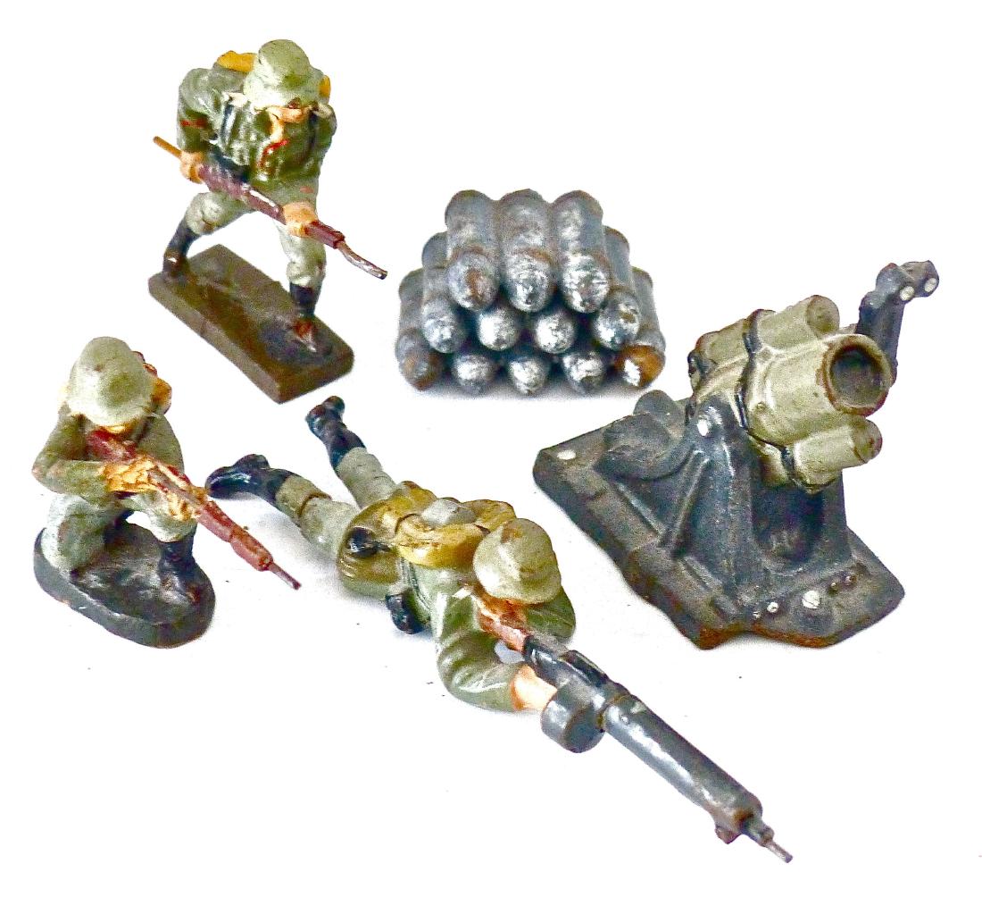 Lineol Elastolin Mortar Shells 3 German Combat: Shell stack and soldier kneel with rifle both Elastolin. Chip in rifle and general wear to shells. Mortar with nice color and complete sight but chip off front of base. Machine gun and soldier chargin