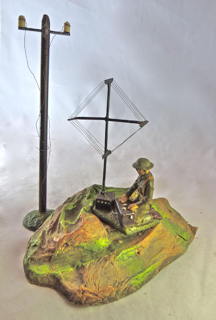 Lineol US Radio, Antenn, TelePole and Plastic Hill: Plastic hill is postwar and has a few scuffs and holes. US Soldier kneeling at radio has thin neck crack and just some light wear. Telephone pole is complete with just light wear. Both made 1934-39. 3