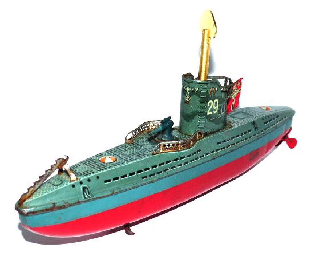 Rare Arnold U-29 Submarine with Motor and Key: Couple of small nicks, scratches with excellent lithographed detail/ color. Front of conning tower has Wehrmacht Eagle with Swastika below. Hausser Battle Flag added at back.12 inches long. Motor work