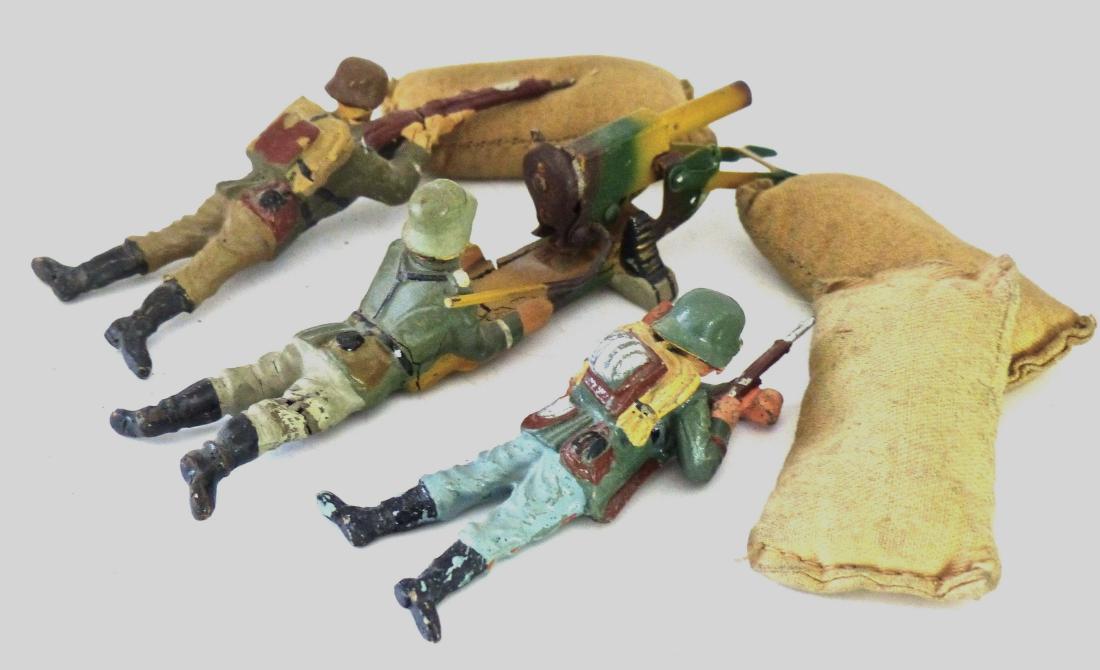Lineol Cap Firing MG 2 Elastolin Soldiers Sand Bags: German soldier at machine gun with leg crack and just light wear. Gun excellent and it cocks and fires. Elastolin soldiers with some touch-up and light wear. Sand bags with no tears and good cloth. 6