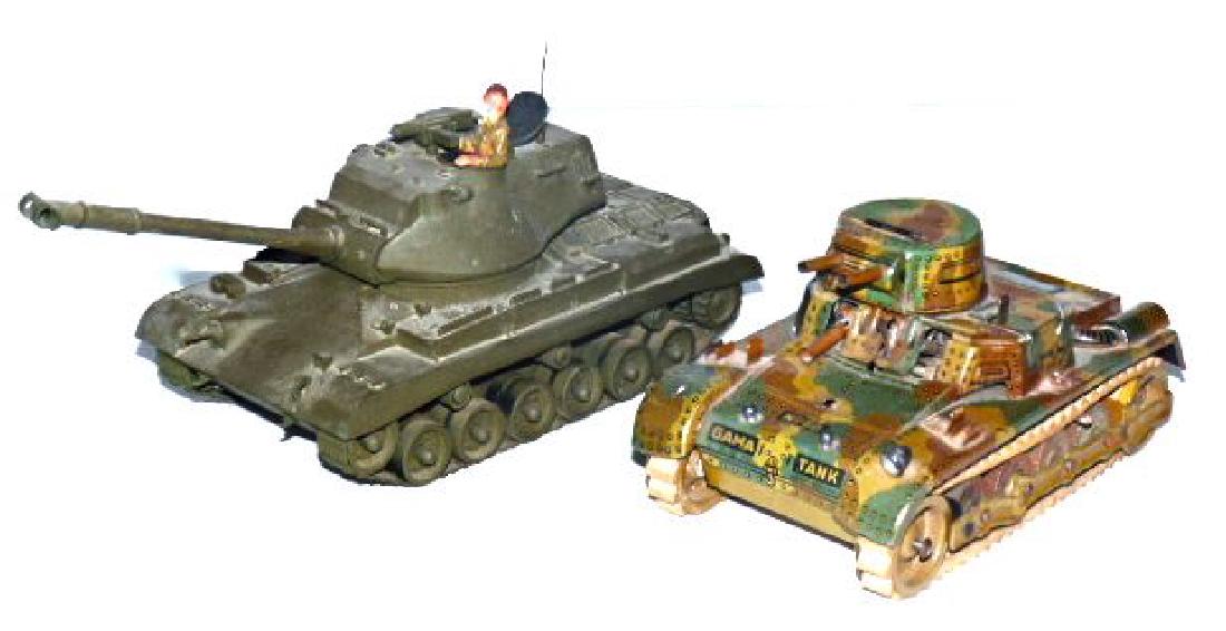 1 Gama Postwar Metal Tank and 1 Plastic Tank: Postwar Gama tank missing tools and 1 machine gun. Motor runs haltingly. Treads intact and excellent. Overall the body is very good with nice lithographed detail. The plastic tank has rubber tracks th
