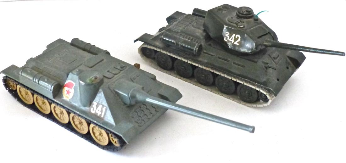 2 Russian Made 1 Tank 1 Mobile Artillery: Metal tank has just some light wear. Treads are intact and plastic. Turret turns. Metal self propelled gun has plastic treads. Hardly any wear. Barrel raises/ lowers. Both tanks about 6 inches long. 2