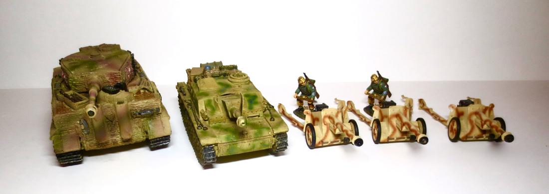 King & Country World War 2 Military Assortment: Includes, Michael Wittman's Tiger Tank, Waffen SS Tank, Anti-Aircraft Guns and Soldiers. 7 pieces. Very good condition. No boxes.