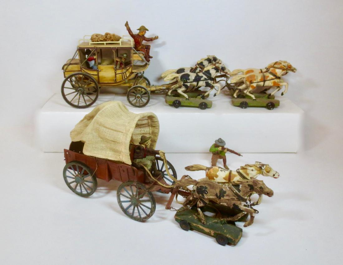 Elastolin Composition Stage Coach Sets: Elastolin Stagecoach drawn by 4 horse team with driver and 2 passengers. Elastolin Pioneer Covered Wagon with 2 horses and driver plus settler on the ground with rifle. Good to Fair condition (with pa