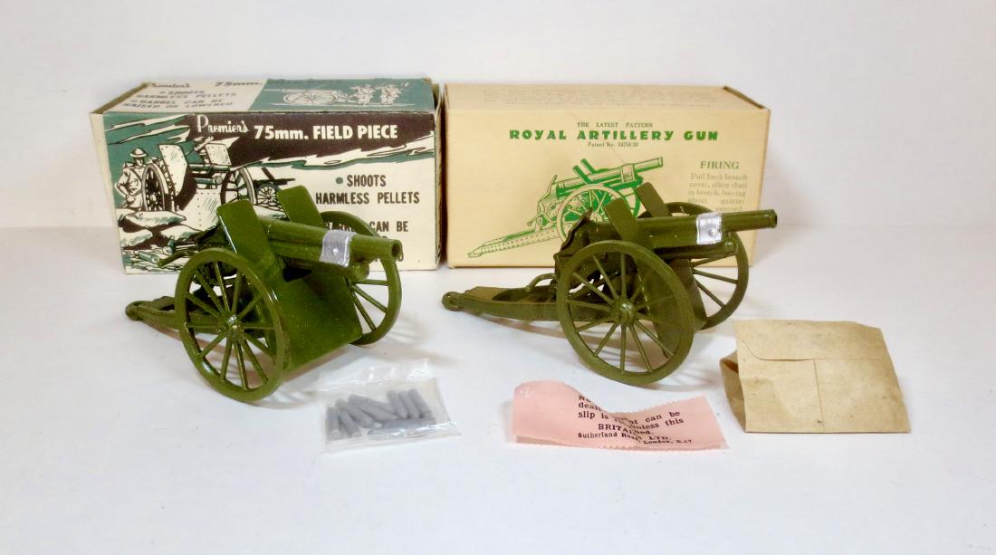 Britains and Premiere's Field Artillery Guns: 2 pieces. Includes Premiere's #112 75mm. Field Piece, and Britains #1201 R.A. Gun. Excellent condition. Both come with shells, still in their inner packet.