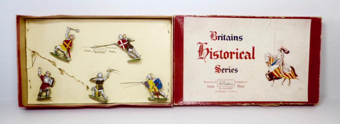 Britains Set #1664 Knights of Agincourt: 5 pieces. Post-war, re-tied in box. Very good to fair condition, with some paint loss and one knight missing top of his weapon. Box fair, with fading and tear on top side. Inner card torn.