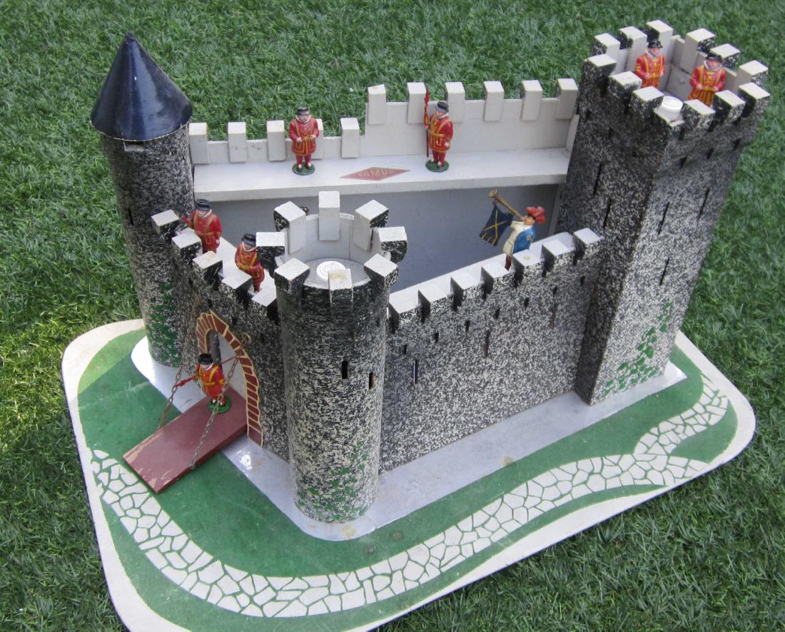Samud French Castle Circa 1960: Very interesting triangular format Castle of wood & masonite with cardstock cone roof circa 1960. Clever ring in back wall pulls up gate ramp. Measures 20" long, 22 1/2" deep, 14 3/4" high, & comes wi