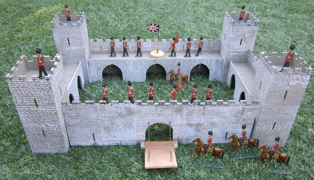 English-Maker Modular Wood Castle: 1970s vintage all wood castle. Can be used as rectangular castle measuring 16" long, 14" deep, 8" high, or stretched out as 60" linear display behind your soldiers. Comes with 20 tin litho soldiers. 2