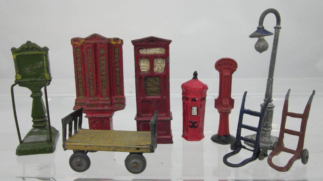 Varied Maker Railway Station Ephemera: Railway ephemera, including weight machine, lamppost, cigarette vending machine, luggage trolleys & others. 9 pieces. Condition very good, no paper face on weight machine.