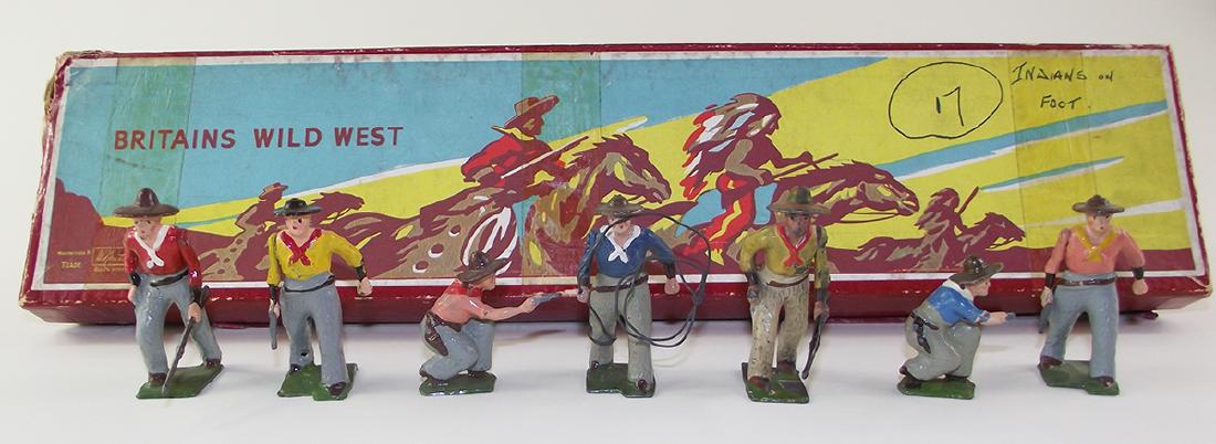 Britains Set #183 Wild West Cowboys: 7 pieces, excellent to near mint. Box is very good with original tie card. There is tape repair to one corner of the lid. One kneeling cowboy missing his pistol.
