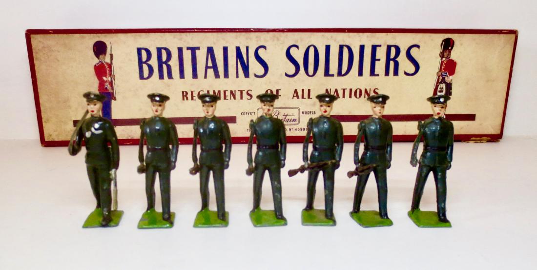 Britains #2091 Rifle Brigade Marching at Trail: 7 pieces (missing one figure). Excellent to good condition (one rifle missing). Post war in ROAN box. Box good (one top corner split).