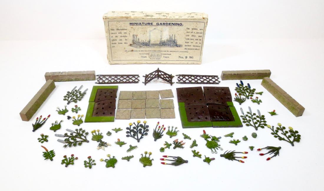 Britains #9MG Miniature Gardening Set: 74 pieces. Excellent to very good condition (stone walls, flower beds and flowers in excellent condition. Trellis bottom posts broken). Pre war in Illustrated box. Box fair (top has several tears with
