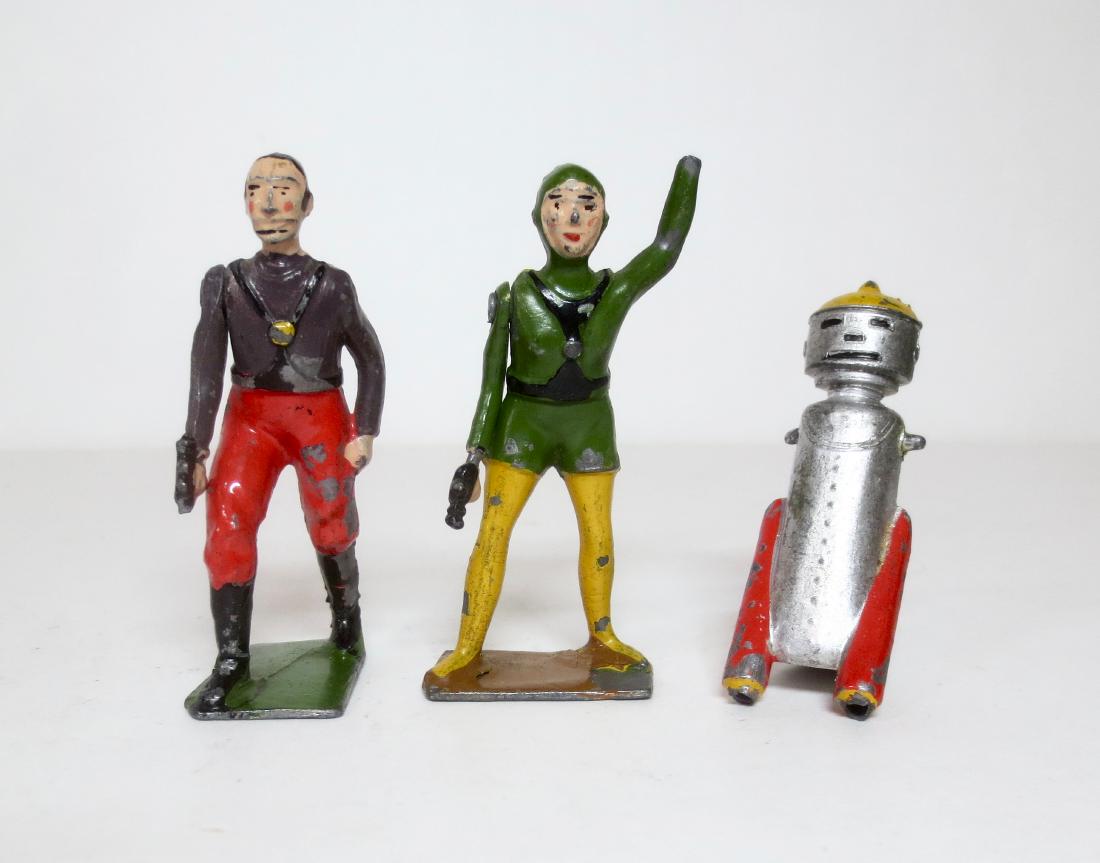 Britains Rare Buck Rogers Figure Assortment: 3 pieces. Includes; Killer Kane, Princess Ardala, and Mekkano Man. Circa 1935. Fair condition (Kane is missing the tip of his ray gun, Ardala is missing one hand, and Mekkano Man is missing his base).