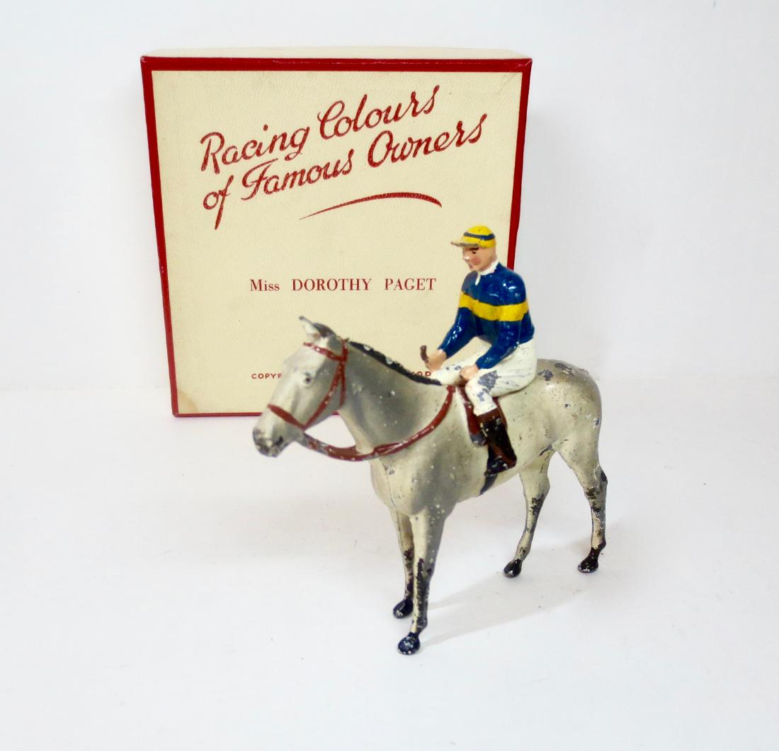 Britains Racing Colours of Famous Owners: 2 pieces, Racing Colours, Miss Dorothy Paget. Excellent condition (with a bit of paint loss on horse's side). Post war issue in Racing Colours Cream and Red coloured box. Box excellent (missing inner 