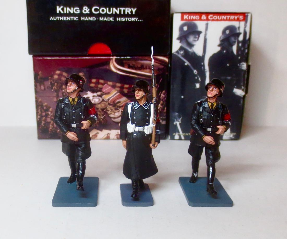King & Country SS Assortment: King & Country Winter SS Soldier Marching with Rifle (#LAH074), and 2 Goose Stepping SS Soldiers (#LAH175). Retired figures. 3 pieces. Excellent condition. Boxes excellent.