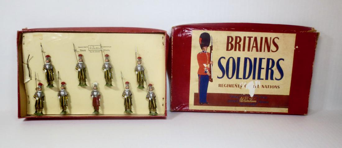 Britains #2022 Papal Guards: Post war tied to card in R.O.A.N. box. 9 pieces. Excellent condition. Box poor (water damaged, with corner splits).