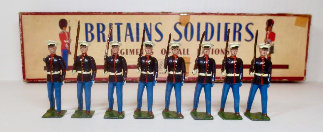 Britains #228 The U.S. Marine Corps: Post war with R.O.A.N. box. 8 pieces. Very good to fair condition (officer missing arm). Box fair (some wear and tear, and missing inner card).