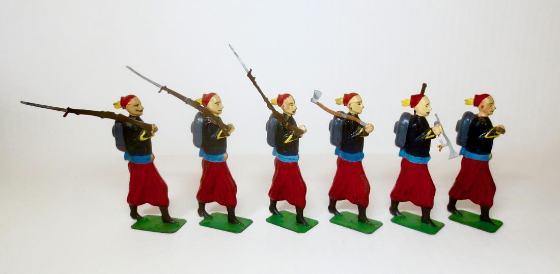 Edmond Faivre (FV) RARE 90mm Tin Zouaves: Rare circa 1890-1920. Unusual 90mm scale tin semi-round Marching Zouaves with rifles, pioneer axe, and bugle. 8 pieces. Excellent condition (one figure missing axe). Unboxed.