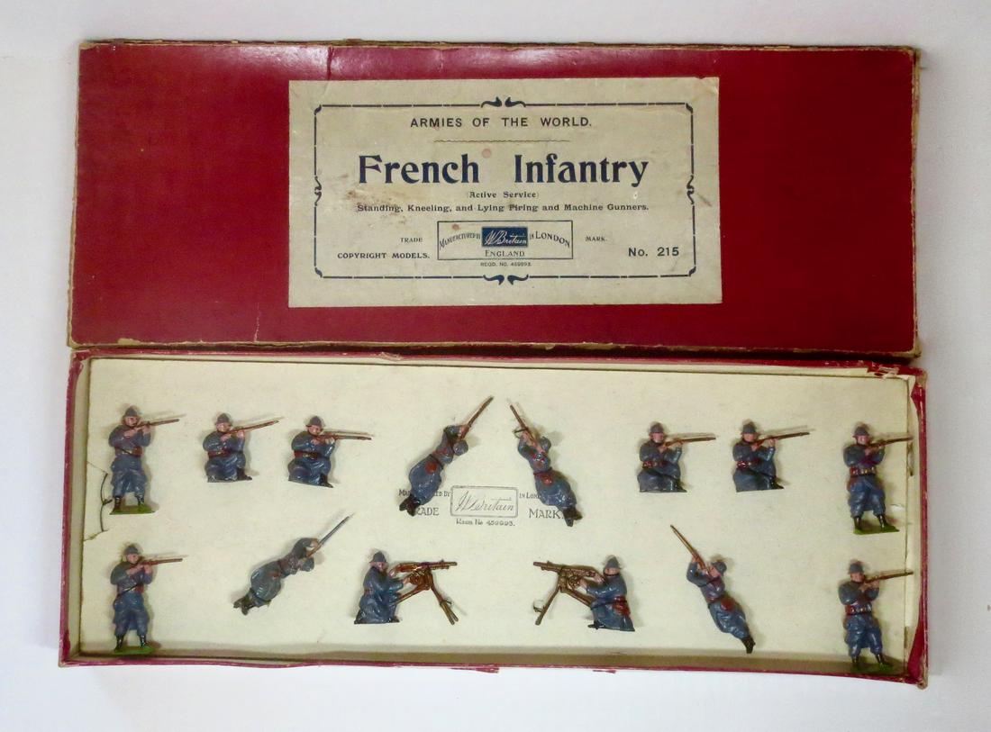 Britains #215 French Infantry Display Set: French Infantry Firing. 1920 version, tied in Armies of the World box. Horizon blue uniforms with steel helmets. 14 pieces. Excellent condition. Box fair (top corner and side splits, general surface w